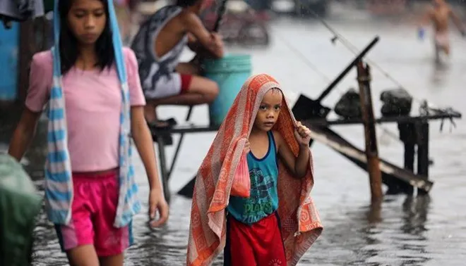 Người dân ở phía bắc Manila hứng chịu cảnh lụt lội hôm 16/12 sau khi cơn bão Melor đổ bộ vào quốc đảo.