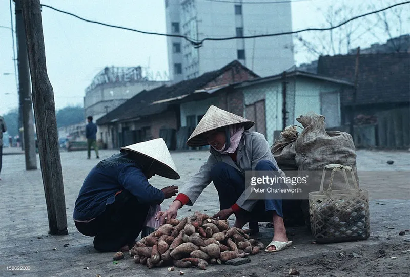 Những người phụ nữ bán khoai lang trên một con phố vắng.