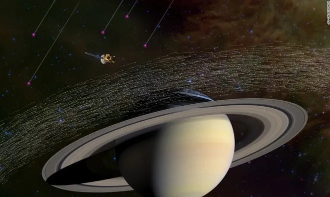 Hình minh họa trên mô tả hàng triệu hạt bụi mà tàu vũ trụ Cassini của NASA lấy mẫu gần sao Thổ.